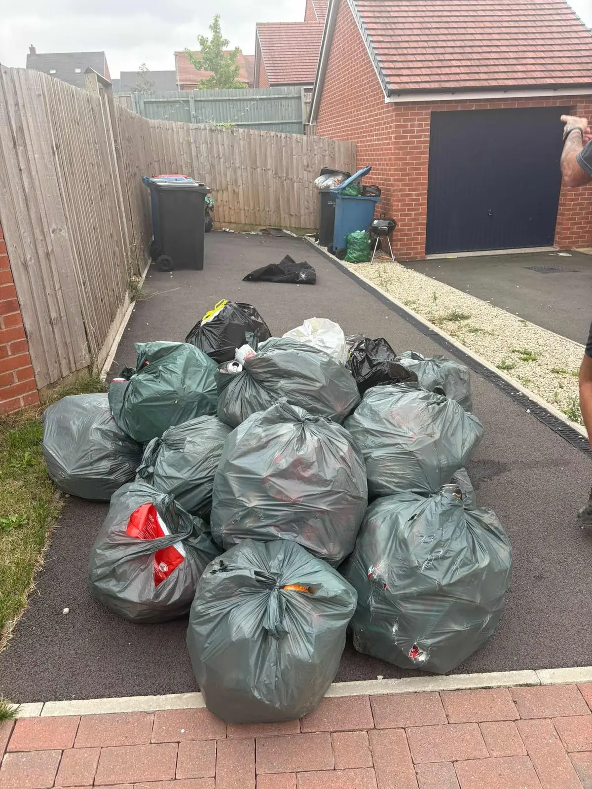Bagged household waste stacked tidily during a house clearance